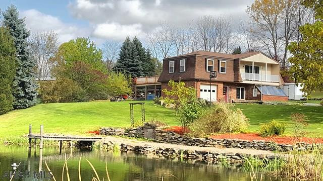 This beautiful unique home sits on 2.4 acre lot that has a pond and 5 bay detached garage!! The home features reclaimed old wood beams, trim and stain glass accent windows. Main floor is ground level with foyer, living/kitchen combo, dining room, 3/4 bath, laundry room, utility room and heated sun room. Second floor includes a large family room.with balcony, Master bedroom with en suite and walk in closet, 3 additional bedrooms and another full bath. Large deck off 2nd floor enclosed porch. Stamped concrete patio with hot tub. Shed.