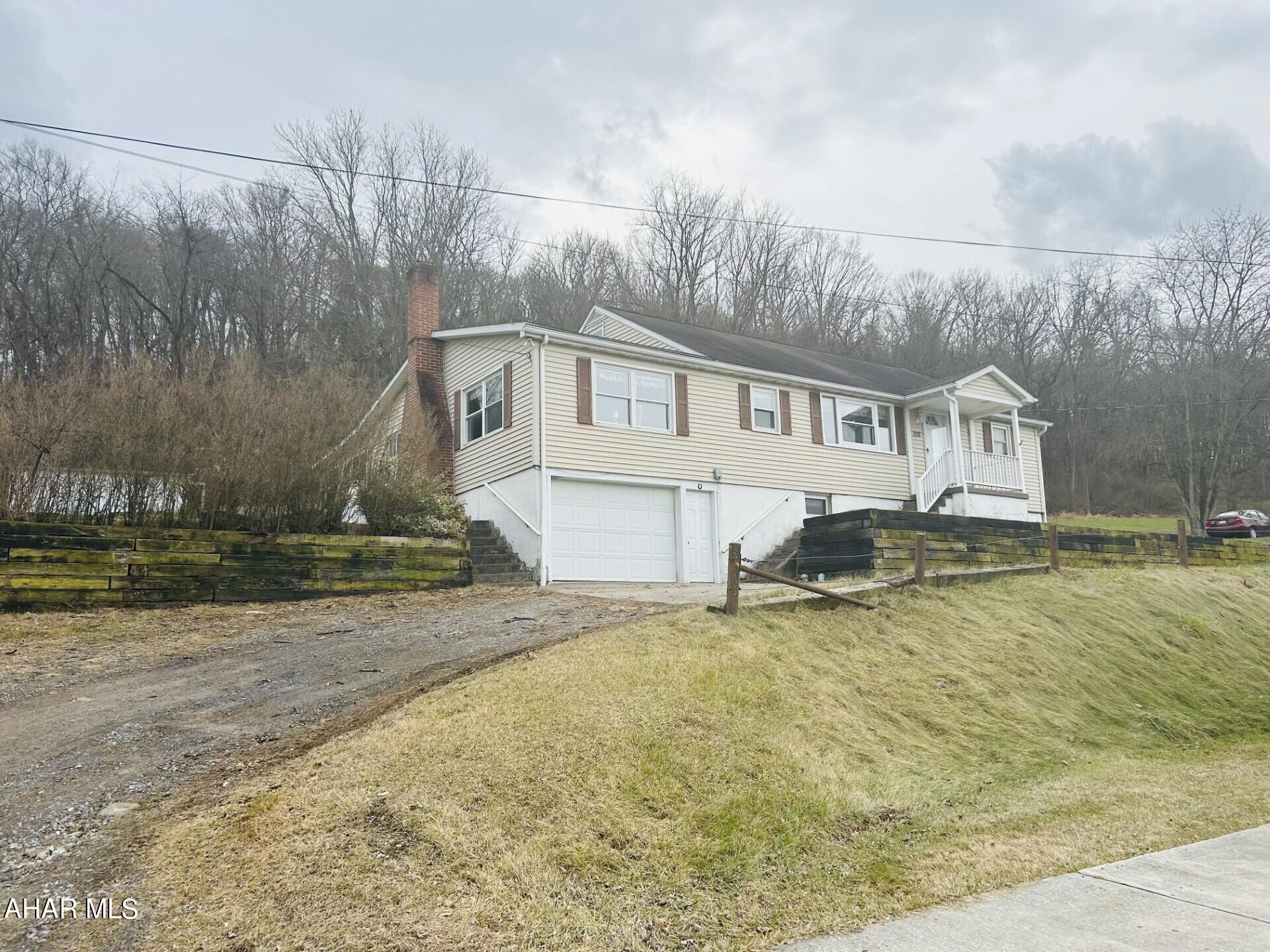 This lovely well-kept home over-looking Hollidaysburg has 5 bedrooms and 2 baths and features some hardwood floors and some carpeted floors, a spacious enclosed sunroom, and a partially finished basement.   There is plenty of parking and storage with an integral 1-car garage and a 2-car detached garage with water and electric and loft above the garage area. With the large yard, this property offers lots of space for the whole family.