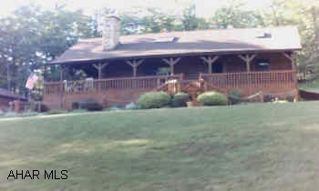 Log home Beautifully landscaped in quiet setting.  Shed on property.  Finished pine wood floors in loft.