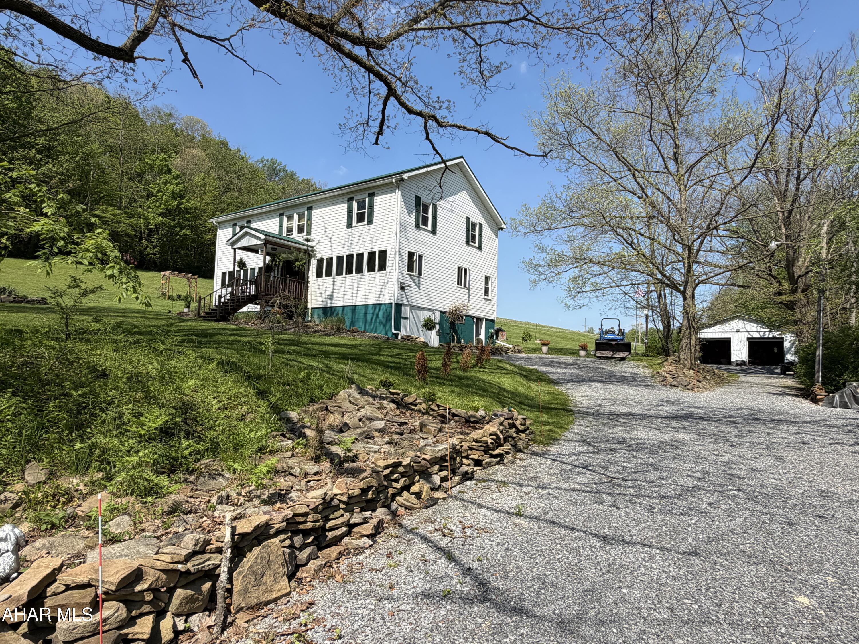 Look no further as your country paradise awaits! This massive 5 bedroom 2 bath farmhouse sitting on 14.5 beautiful acres will allow you to have animals if you like or simply enjoy hiking and hunting on your own property! If you love to fish a fully stocked stream is right across the street! The chicken coup, well house, barns, shooting range and large garage will give you plenty of options for hobbies.  The garage has a heated bonus room that will allow you to enjoy your hobbies all year long.  Let's talk about the house... this large home has plenty of family living space on the first floor starting with the spacious kitchen/dining area that can accommodate a large crowd.  The island is great for meal prep and will allow you to mingle with guests.  New windows brighten the living room that features a pellet stove for warming up on chilly nights.  The foyer has room for an office area and plenty of coat storage.  There is a first floor laundry room with storage for clothes and a 3/4 bathroom for guests complete this floor.  The second floor has 5 bedrooms, a space for everyone a full bath centrally located in the middle.  Call today for details on this expansive county retreat the perfect mix of indoor living and endless outdoor freedom.
