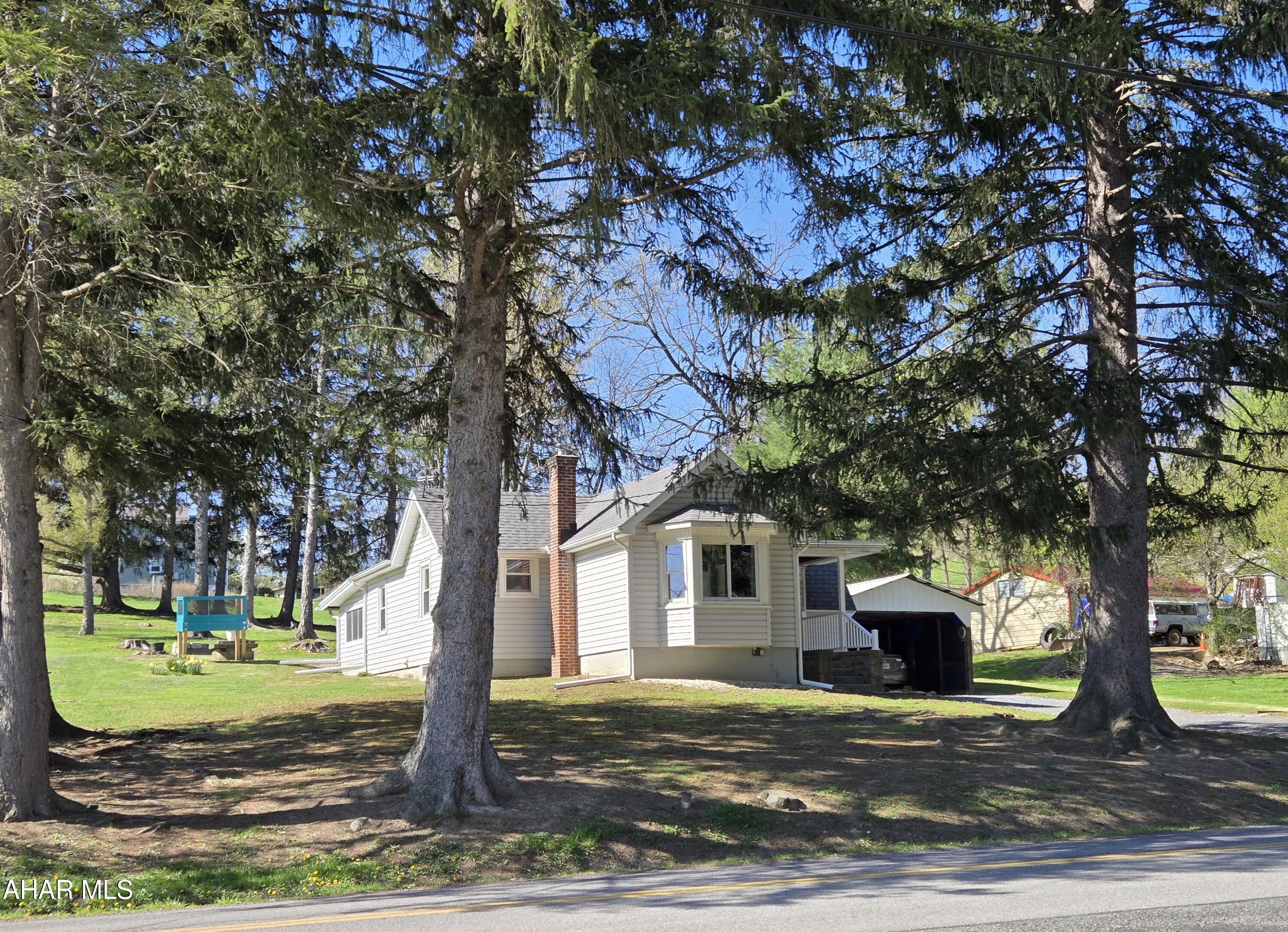 Hollidaysburg School. Updated 1 story vinyl sided 2 bedroom, home with 3 season room, great views, updated kitchen , bath and flooring, plus tarped sided carport on
.58 acres. J-683