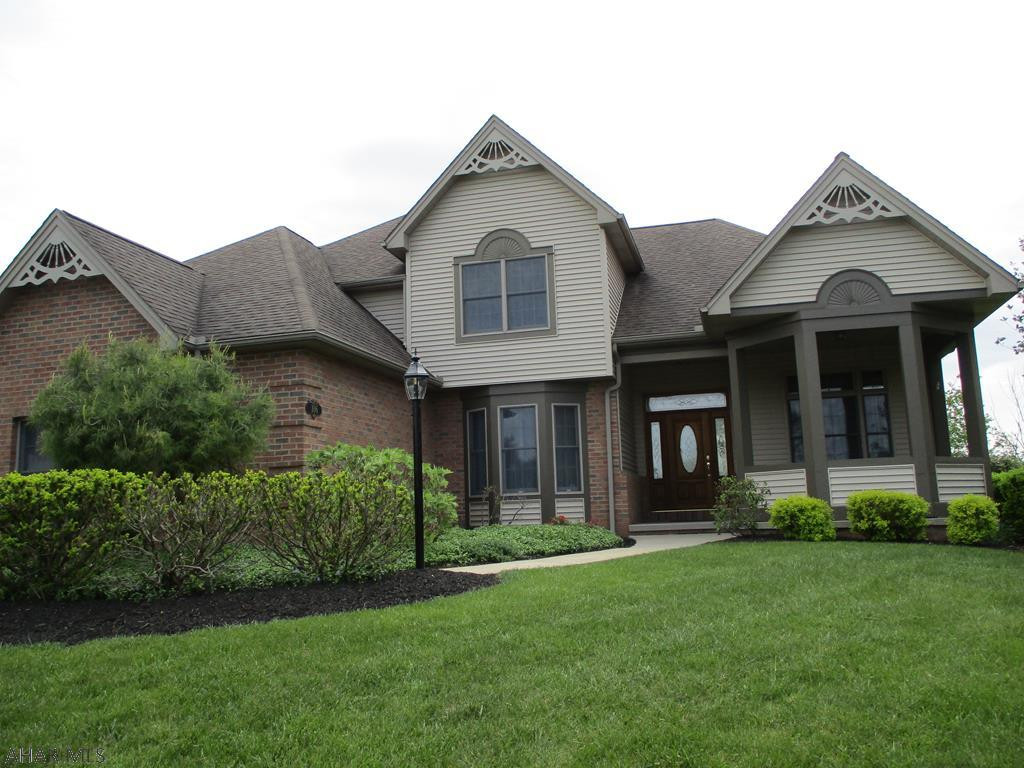 Gorgeous views offered free!  Stunning throughout.  The kitchen offers granite countertops, tray ceiling in the breakfast nook area and ceramic floors.  Prepare your meals on the center island while talking with your guests in the great room (open concept), Stainless steel appliances and pantry.  Spacious covered porch in rear.  The Great room has fabulous Hardwood floors with fireplace and is open to Kitchen area.  Formal Dining room has hardwood floors as well. The Master Bedroom is just down the hall (soak in the Jacuzzi tub in the Master bath) Laundry is located adjacent from the kitchen as well as 1/2 bath for guests.   Upstairs is 3 bedrooms and 2  FULL baths.  Storage is NOT an issue - Lots of closets & Basement is huge, easy to finish.  3 car garage, 3/4 acre!  Call agent to see.
