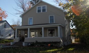 Large 4 bedroom, nice front porch, rear deck, Large 2 car detached garage new wiring, new flooring, formal dining room, large foyer. Must See Inside!15x20 Deck, All new windows in 1999, Updated kitchen, Blown insulation w/rolled insulation between rafters & attic, new carpet throughout, new vinyl flooring in kitchen and bathroom, replaced plaster w/ drywall through the entire upstairs, new electric service, all new fixtures throughout, new roof installed in 2006, all new vinyl siding, 30x32 garage in 2005. $1,000 bonus to Selling Agency
