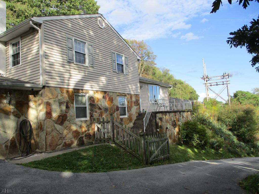 Looking for seclusion but near shopping and other amenities?  This is the home for you!   Built in 1977, the home has had kitchen and bathroom upgrades recently as well as new thermopane windows.  Laminate flooring in many rooms.  Furnace new in 2014.  Economical oil hot water heat.  Huge family room with woodburning fireplace, and 1/2 bath for all your entertaining plans.  Large deck around pool and at rear of the home offers very private outdoor recreation opportunities.  Measurements and taxes from courthouse records; Buyer to confirm.  .