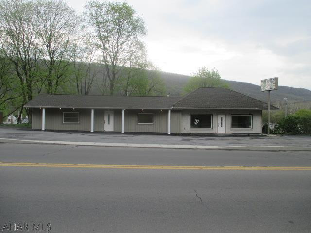 Tyrone Borough 1 story commercial space. 2 large, open rooms. Currently there is 1 functional 1/2 bath and another room plumbed for a second 1/2 bath. Lots of off street parking on this corner lot. This is a block building with brick and metal exterior and shingle roof.