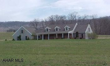 This home truly has lots of inner and outer space.  It offers five bedrooms, living room, family room, sitting room, dining room, kitchen and 2.75 baths.  This home was built in 1997 and rests on 14.5 gorgeous acres.  This property is offered "as is".  (Directions:  Route 30 West to Route 31.  Proceed straight through blinking light in Manns Choice for two miles.  Make a left onto Sulphur Springs Road, go 1.2 miles to left on Milligans Cove Road.  Go 1/2 mile to house on the right.)