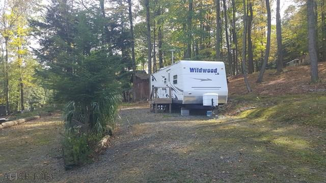2008 30' Wildwood T camper on two beautiful lots in Glendale Yearound. These two lots are setup and ready to be used yesterday. Perfect for the outdoorsman. The camper can sleep 10 so there's room for the whole family and even extended family. There are two sheds on the property with electric run to both. One is setup as a rustic kitchen and the other as a workshop/mancave. Glendale Yearound is a gated community minutes from Glendale Lake and Prince Gallitzin State Park. Community Pool, Security, Basketball, Tennis, and more.