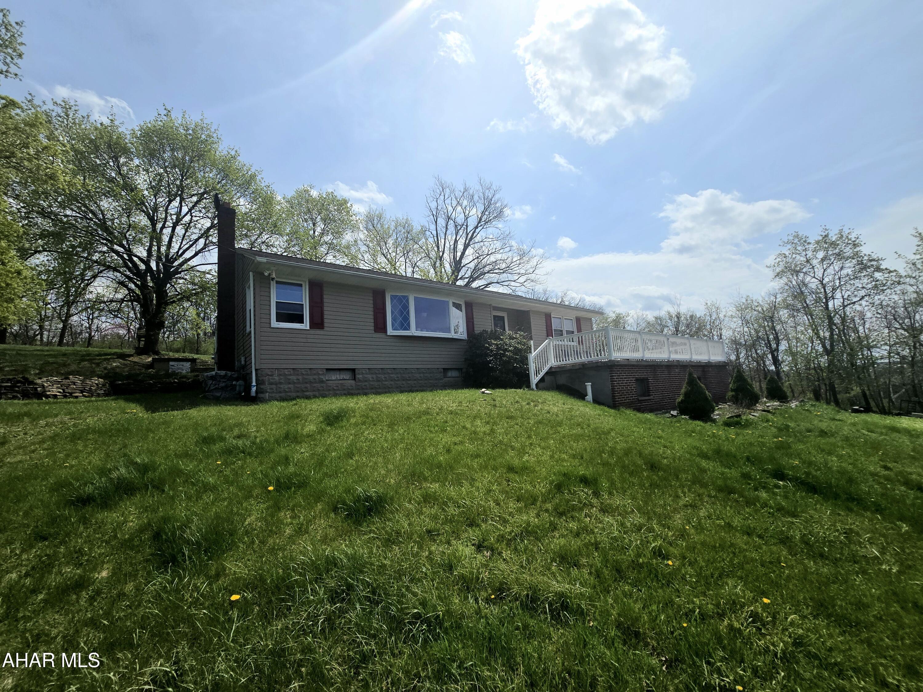 One story living within walking distance to Penn State Altoona!  Situated on 1.87 of an acre this home offers the perfect mixture of privacy, comfort, convenience, and space.  Enter the front door at the main level where you will find 3 spacious bedrooms, 1 full bath, oversized living room, dining room, and eat in kitchen.  The basement has a family room with wood burning fireplace and full bath for additional living space.  The outside speaks for itself!  With your own finishing touches this property can be everything you have ever dreamed of.  Potential like this will not last!  Schedule your private showing today.