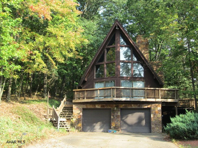 Bank owned property.Quiet wooded setting. If you are looking for a unique setting and house this is it. This house has quality construction but is in desperate need of updates. The large private master bedroom,the two fireplaces and finished lower level make it a must see. The bank that owns this house will look at offers from qualified buyers.