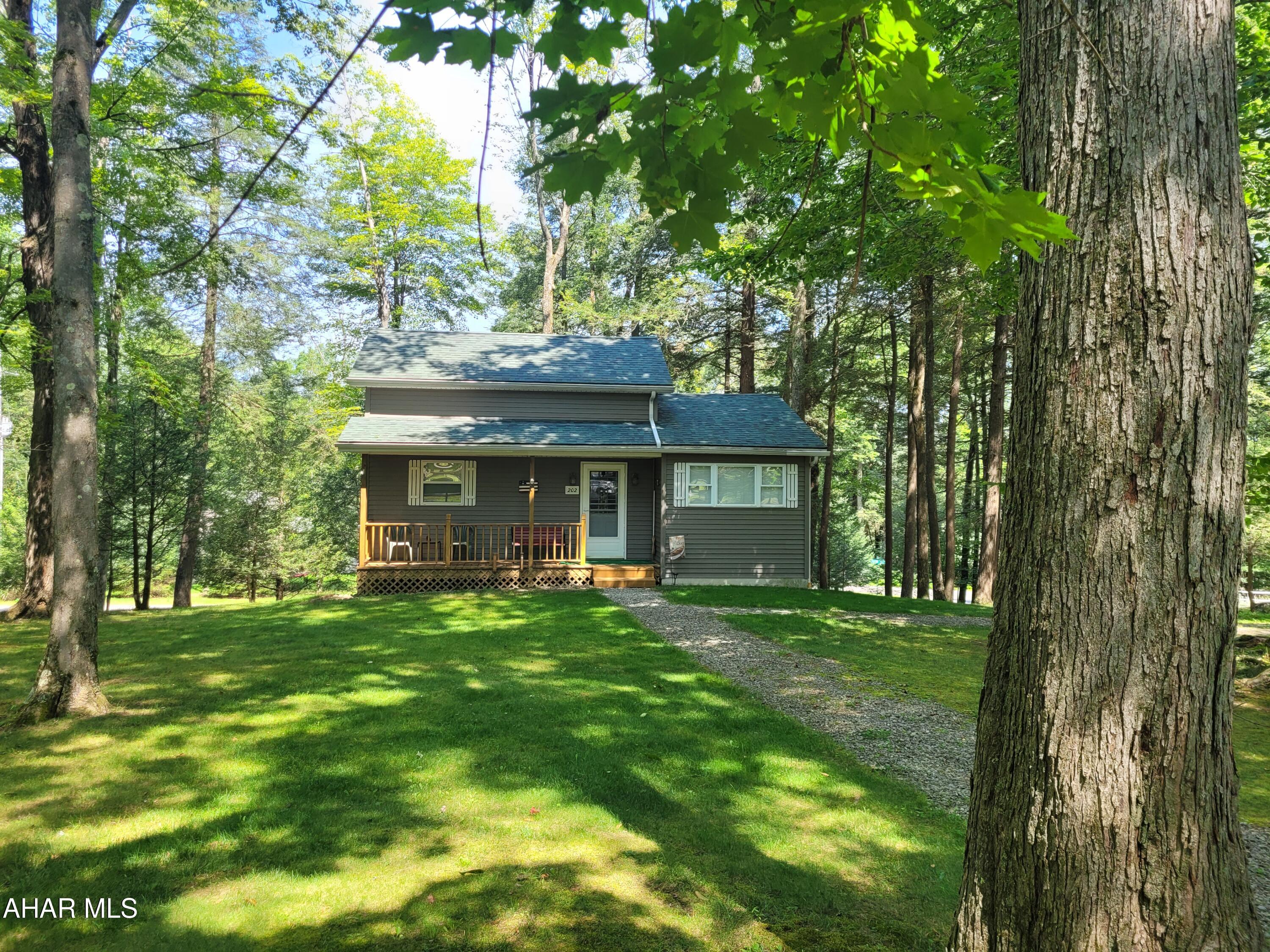 Situated in the center of over 3/4 of an acre of wooded land you  will feel the peace and privacy this cabin offers..  This one owner cozy cottage has been well maintained.   First floor bedroom and full bath offers the convenience of one floor living.  The loft can be used as a separate sleeping space, another living space or a storage area.  Step out onto the back deck and soak in the enjoyment of watching the deer and other wildlife close up.
The furnace, water heater and oil tank are out of sight but readily accessible in the walk in crawl space.
You will find added storage space in the shed.
This cabin is located in Glendale Yearound, a gated community adjacent to Prince Gallitzin State Park.  Community amenities include a heated seasonal pool, tennis/basketball/volleyball courts, dog park, clubhouse, pavilions, playgrounds, etc.