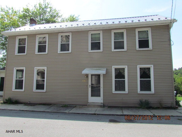 Spacious tow story home convenient to Lake Raystown- 3 bedrooms with bonus room on 2nd floor that could possibly be a 4th bedroom, toilet off of laundry area could be an additional bathroom, shaded lot, large enclosed three season porch, some tlc would make this a great home or vacation property. Property being sold as is.  Physical address is 5592 Bouquet St, McConnellstown, PA