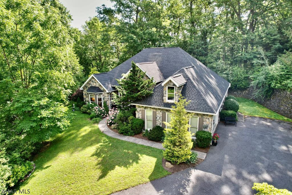 Wow...This is a spectacular one story stone home.  Everything about this house just warms the imagination. Its magnificent curb appeal, fabulous floor plan & amazing location surrounded by trees and nature within a minute of town will impress. The moment you enter, you are surrounded by nature through its many huge windows, cathedral ceilings & architectural appeal. One can imagine cooking up meals while enjoying guest & family in the open concept design. Enjoy natural gas radiant floor heat & fireplace while gazing through transom windows in every direction. A private owner's suite with two walk in closets is privately located in a separate wing of the house. New HVAC, roof, garage doors, paint, flooring, appliances & renovated bathroom and so much more.  Stunning home will not last long!