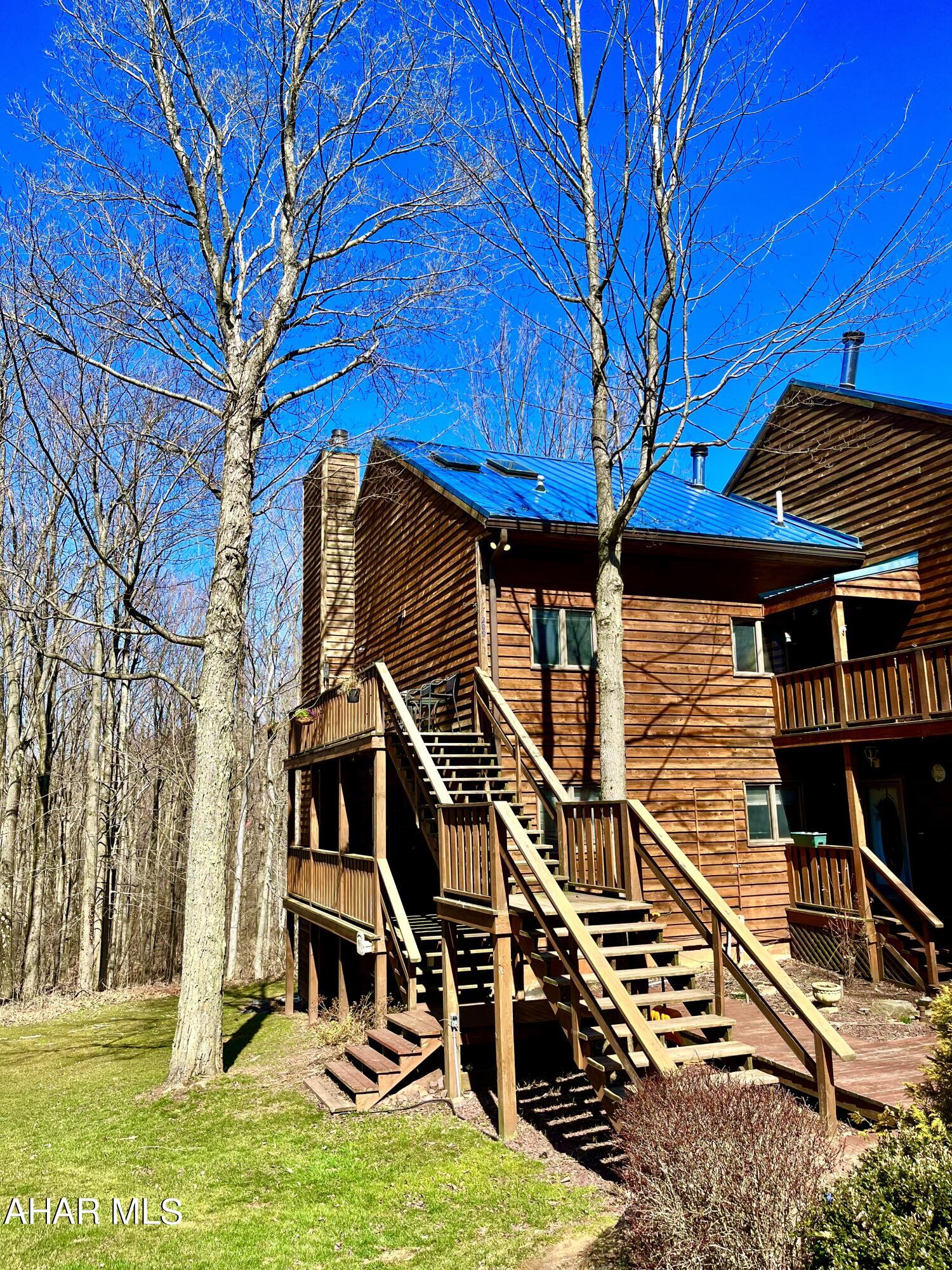 Where rustic meets elegance - Step right up into 209 Moss Creek Drive, where you'll feel immediate relaxation and content in the heart of the mountains. This well-maintained condo is looking for its next owner! Whether you are looking for a full time living space or a cozy vacation retreat, this has everything to suit your needs! This is a 2BR, 2 full bath home featuring immaculate stone floor-to-ceiling wood burning fireplace, updated flooring throughout, solarium with baby grand piano that is perfect for all seasons with panoramic views of forestry and wildlife, and separate dining space just off the kitchen. The open floor plan of this entire space offers many possibilities of how you could make it your own. Plenty of storage throughout as well! The main bedroom is very inviting with solid oak french doors and stone based garden tub. This location is close to major highways, minutes from desirable Blue Knob State Park, and perfectly situated between Bedford and Altoona. Close to shopping, but away from the hustle and bustle. This condo also features two 1-car garages as an added bonus for extra storage and parking. HOA fees include: Water, Sewer, Trash, Outside Maintenance, & Outdoor Power.
The mountains are calling and you must go!