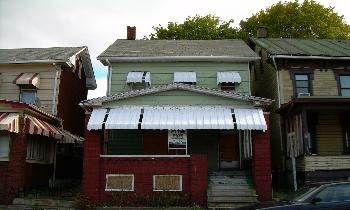 2 1/2 story aluminum sided w/ brick front porch. Home has been vacant for a couple of years.  Great investment property, turn some sweat equity into a rental income.  Property needs work, being sold as is.