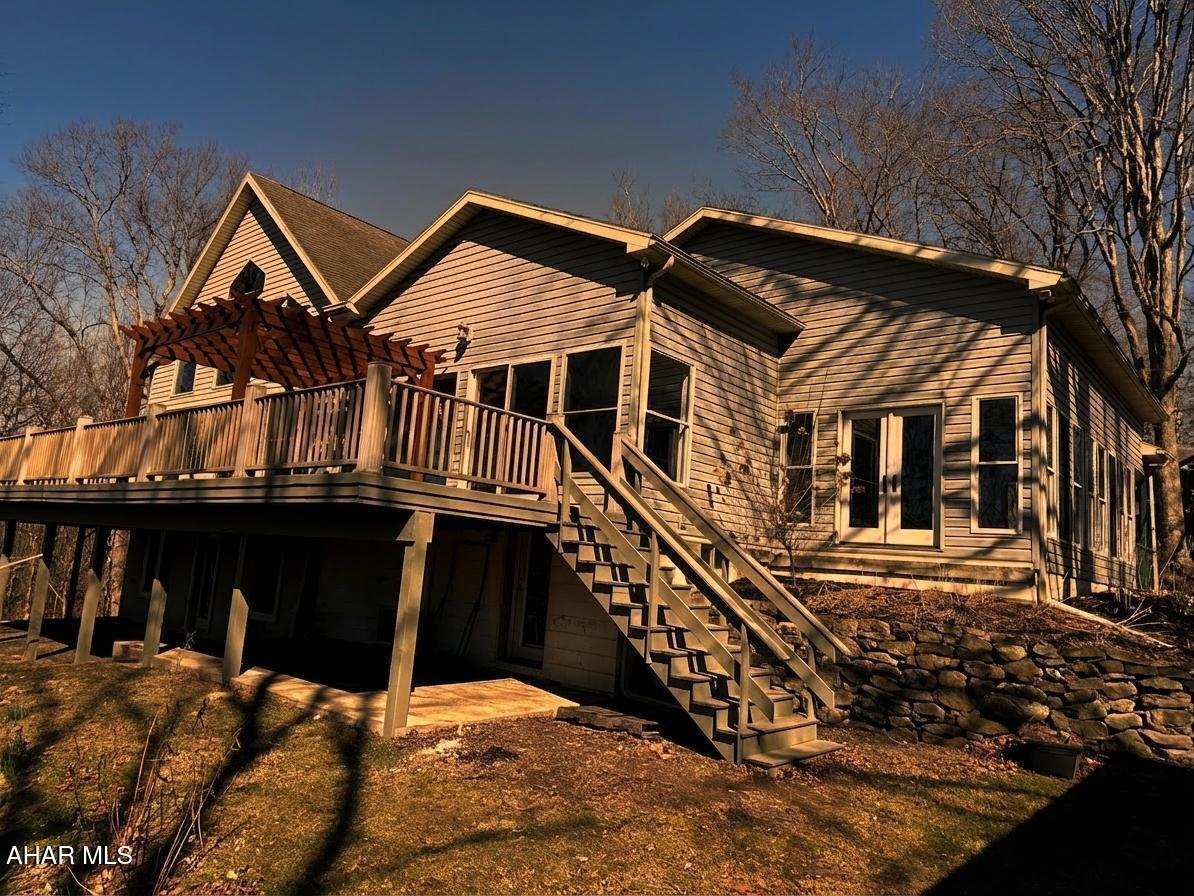 Are you looking for a private retreat? Check out this beautiful property adjacent to the American Legion Country Club in Mount Union. This quality home has a great layout with an open living area. The main living area has a living room with vaulted ceilings and a wall of windows letting in lots of natural light, and an open stairway to the second floor. The kitchen features lots of cabinet space with a walk-in pantry, island and bar area, the huge composite deck can be accessed from the living room or dining area making this the perfect spot for entertaining, the deck has a wonderful view of the river when the leaves are off the trees and lots of privacy all summer long, there is a sunroom off the kitchen, the owner suite has a large walk-in closet and full bath, the upper level offers two bedrooms with a full bath and a bonus room that could be used for an office or nursery, the lower level has two additional bedrooms with a full bath, the bedrooms all have nice sized closets, the basement opens at ground level and is mostly finished with the unfinished areas turned into closets that offer lots of storage, a laundry area and even a half bath, this home is well thought out and offers lots of space for you, your family and friends and all your belongings, call today to schedule your showing