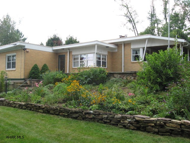 This all brick 2 bed, l bath rancher is nestled on a private, wooded setting but minutes from everything. Spacious kitchen with lots of cherry cabinetry and counter space. Living  rm with fireplace. Fireplace does have a heatilator.  Lots of windows to enjoy the beautiful landscaped yard.  A lovely side porch and flagstone patio. Pleasant Valley area.