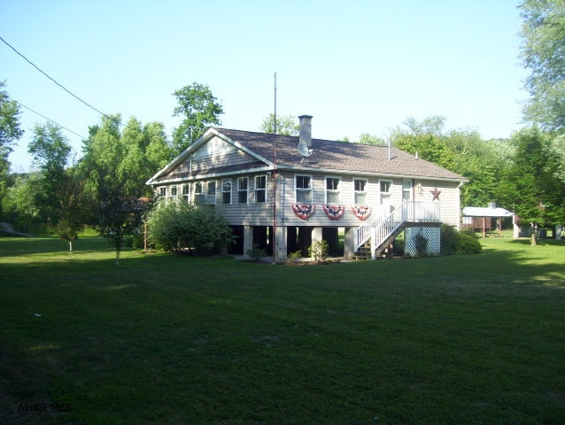 The perfect getaway! Immaculate and spacious, completely remodeled and upgraded, and tastefully decorated, 2BD/1BA cottage on .68 acres move-in ready.  Features include large enclosed porch with 17 windows, ceiling fans throughout, double-pane windows, solar blinds, 19x29 pavillion with ceiling fans, fire pit, 14x20 shed with additional storage space 8x20 under roof, and level yard with mature landscaping.