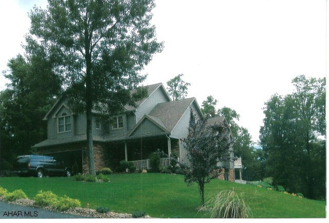 Lovely 2-story in Juniata Mills, Bedford School District.  In ground heated pool. 2-Story vinyl/stone, featuring elegance and luxary. Large kitchen with all appliances, center island, granite counter and back splash. Breakfast nook, living room with gas fireplace, master bath with jacuzzi plus shower. Finished basement with family room, bar area with granite bar top, bedroom and full bath.  Large view rear deck and 2-car attached garage.
