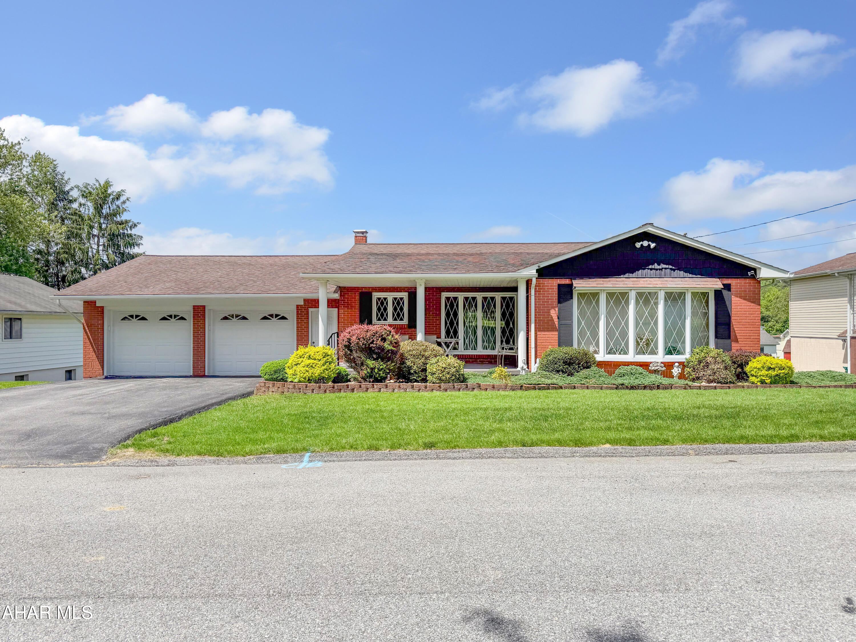 OFFER DEADLINE MONDAY THE 1ST @ 4PM. Welcome to 325 Woodland Street in the Mylo Park neighborhood of Ebensburg. This gorgeous all-brick ranch style home sits on a large lot and has been meticulously maintained throughout the years - a truly rare find. The main floor features a spacious living room highlighted by a beautiful bay window, dining area, and a beautifully updated kitchen complete with stone countertops and newer appliances. You will also find 3 nicely sized bedrooms, a full bathroom, and an additional half bathroom on the main level. The finished basement offers an incredible amount of additional living space featuring a cozy gas fireplace, full bathroom, laundry area, storage, mechanicals, and an additional garage bay with even more storage potential. The exterior is just as impressive with a paved driveway, attached 2 car garage with attic storage, large flat yard, covered front porch, and a rear covered composite deck perfect for relaxing or entertaining. This well cared for home combines quality, space, and location all in one package. Call today for your private tour!