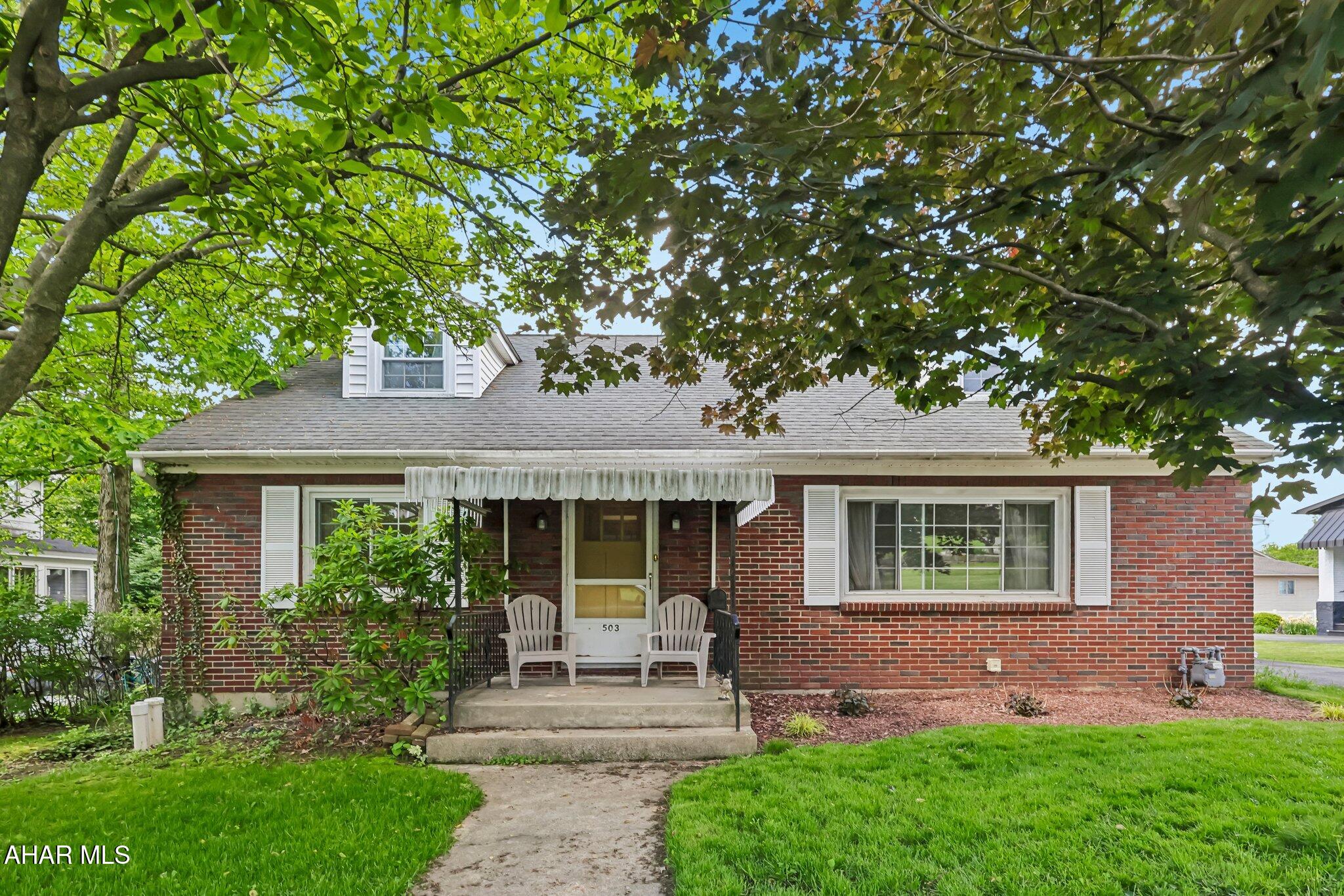 This classic 1-1/2 story brick home is just waiting for the new owner to move in and enjoy the central A/C when the summer heat finally arrives. It offers a paved driveway with an enclosed carport that could easily be reopened; along with a detached garage accessible from the alleyway. The large flat yard provides plenty of space for outdoor activities year-round! Inside you'll find a wonderful living room with large windows for tons of natural sunlight along with a wood fireplace surrounded by a brick surround. The kitchen is directly off of the carport for convenience and offers plenty of cabinetry along with a cute passthrough opening into the dining room. Two of the bedrooms and a full bath can also be found on the main floor; while the master bedroom with it's own full en suite bathroom is located on the second floor. You'll absolutely love the hardwood floor and the privacy up there. The basement offers so much flexibility and functionality with its finished family room area, separate laundry room, and even a workshop! Don't miss your opportunity with this ONE!