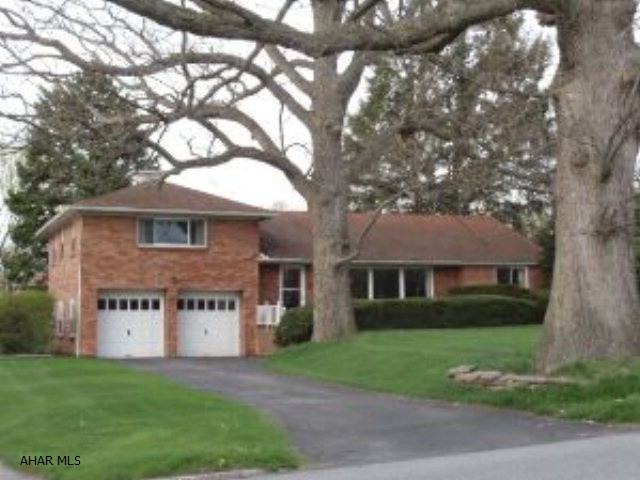 Beautiful 2-story brick home with vinyl windows, living room with fireplace, formal dining room, 3-season sunroom with skylights, den, 1st-floor bedroom & bath.  Finished basement has family room with fireplace, 1/2 bath & workshop area.  J-062
