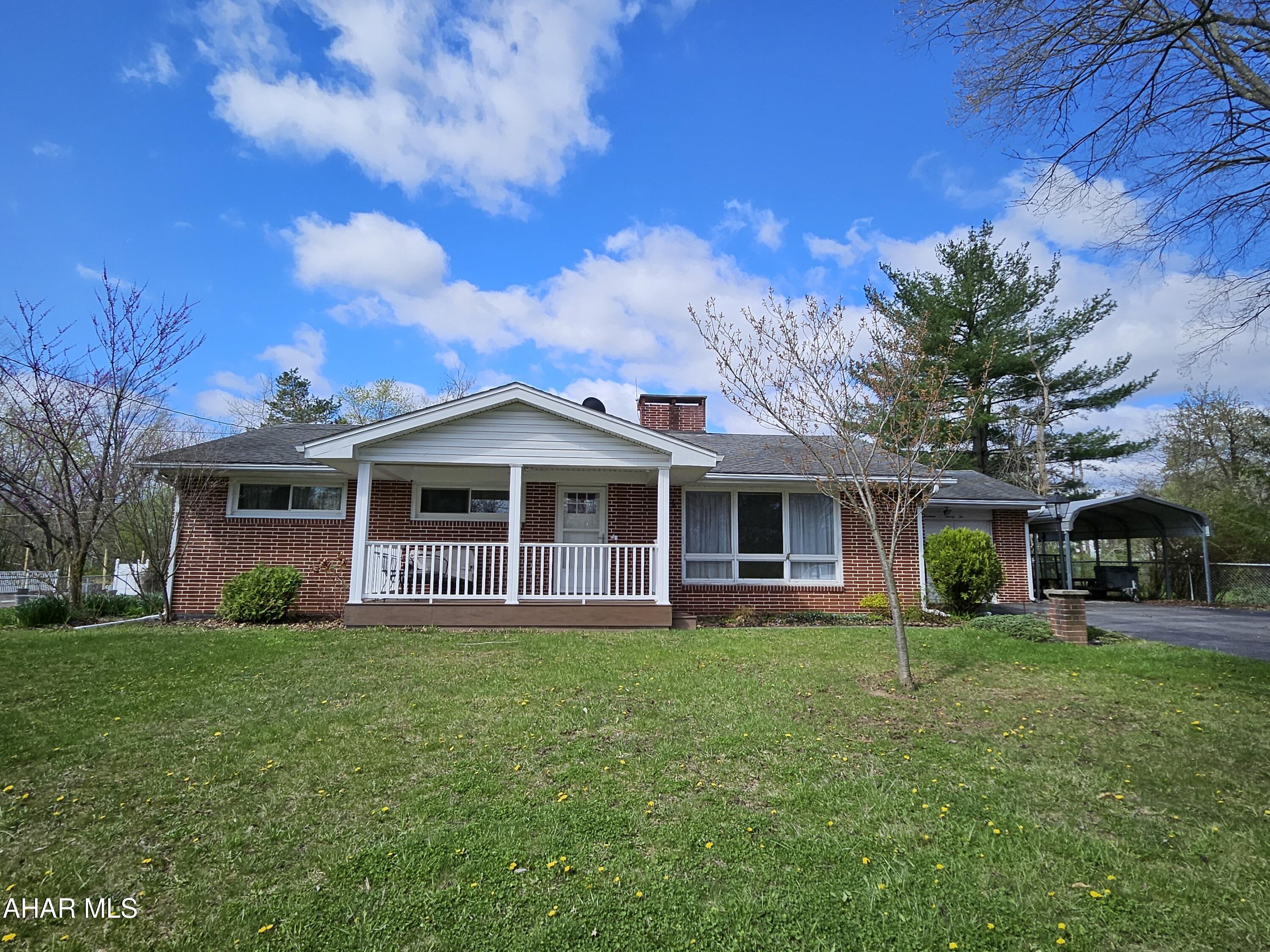 Location, location, location!  This exceptional all brick one story offers a beautiful sun room, double sided gas fireplace, newer eat-in kitchen with all appliances and large bedroom sizes.  A convenient 1/2 bath on the main floor, beautiful hardwood floor and a family room in the walk out basement!  Huge storage area/workshop is also in the basement.  Abundant garage space with 1 attached, 1 carport, 1 detached and a large shed with a beautifully landscaped yard.  Covered Trex deck, gardens. The well in the back still works so you have plenty of water for the flowers!  Don't miss this opportunity!