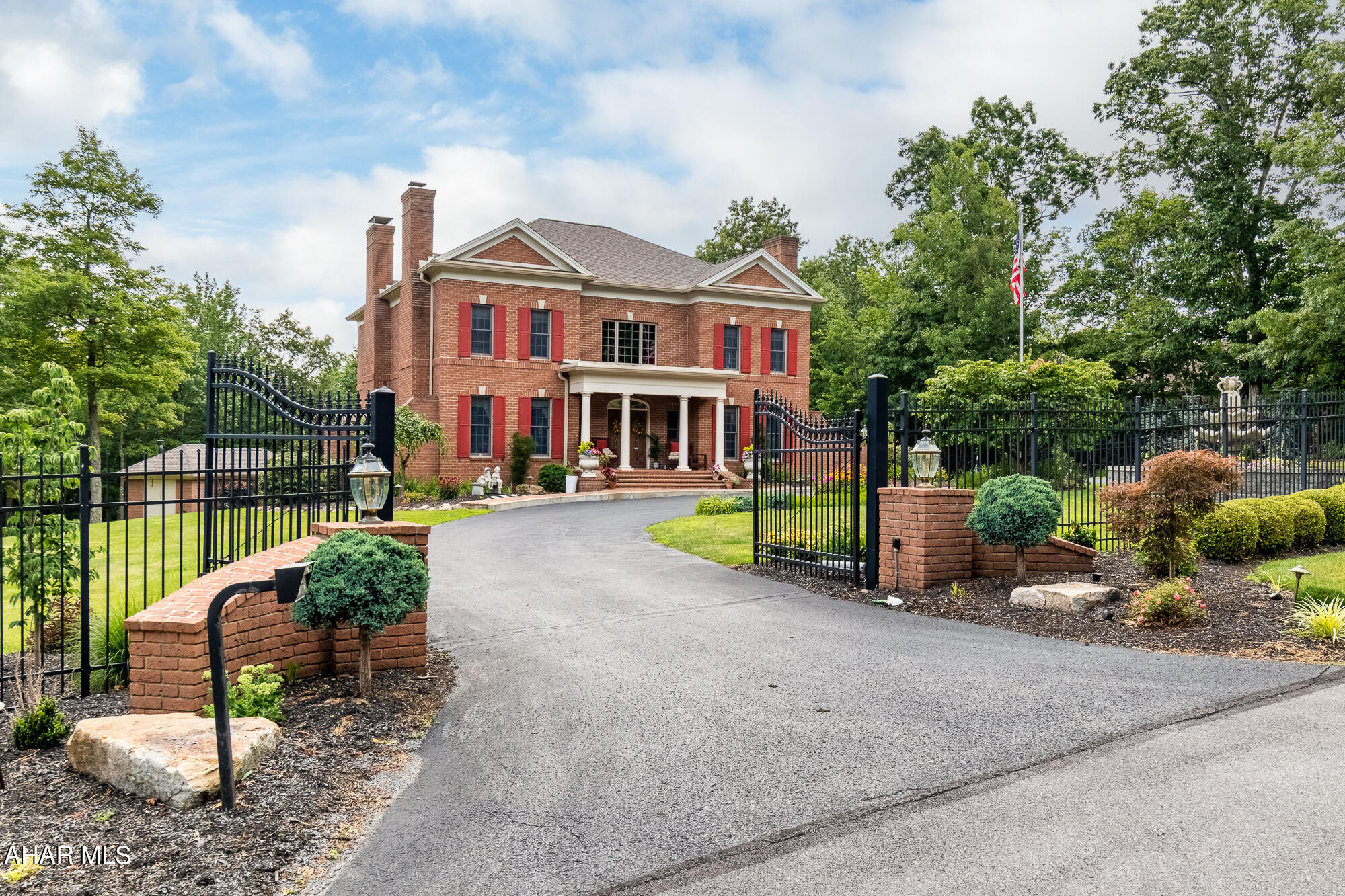 Prestigious Glades Area - Stonehedge - 5BR, 4.5 BA - Enter through the electronic gate to this luxurious 2-story all brick home on 1.03 acres.  Large fountain and professionally landscaped lot add to the  appeal of this charming home.  You will quickly notice the  quality detail this home displays.  Impressive from the moment you walk into the large open foyer. The superior craftmanship is evident inside and out!
Outdoor recreation area is a summer paradise with heated saltwater pool, pool house with changing room, shower and toilet, also kitchen sink, microwave, refrigerator, TV and gas grill. The cabana is great for entertaining and relaxing out of the sun.  New pool liner, pool vacuum, and pool heater. Behind pool house is a door to the electrical for pool, water heater and filtration.
Home Features include: 4 gas fireplaces, cherry crown molding, and hardwood cherry floors, bathrooms have ceramic tile floors, kitchen and laundry have decorative waterproof laminate floors.  Abundant storage and walk-in closets throughout.  There is a Generac generator, new windows across rear second floor of house, and new roof on all buildings.  2 furnaces with humidifier, and 2 gas water heaters.