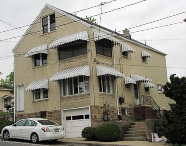 Very well maintained duplex, all brick, large rooms upstairs and down.  4 bdrooms (2 captive) downstairs and 2 bdrooms upstairs.  All appliances included on both floors.  Hardwood floors in excellent condition.  3 yr old gas furnace.  2 separate hot water tanks.  Upstairs was rented for $500.00 a month - rent included heat, AC, and water.  Nice investment property.  A must see - in great condition.  Heat bill - $109.00 a month total for both units.