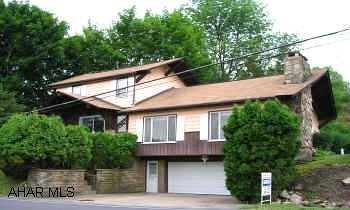 LARGE 1ST FLOOR FAMILY ROOM WITH STONE FIREPLACE.  DRIVEWAY AT CORNER OF PROPERTY GIVES ACCESS TO BACK OF PROPERTY.