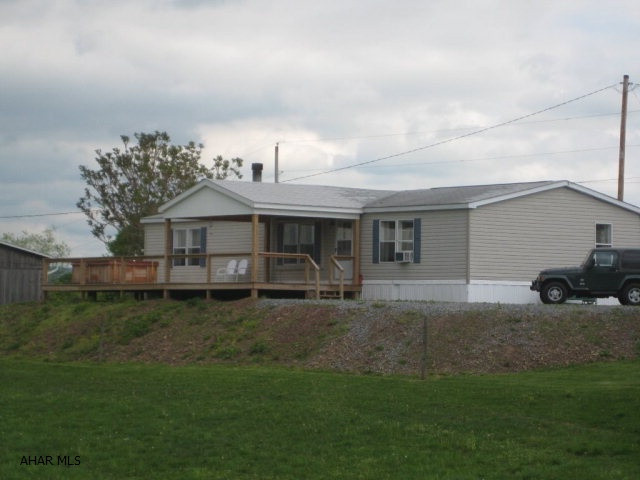 Quiet country living is yours in this updated 28X65 doublewide home situated on 58+ acres. Beautiful Hickory wood floors, updated Master Bath, Stone fireplace in Living Room. Large Bank Barn and Horse Barn with gated riding ring. Both Barn and Horse Barn have water and electricity. Large 12X65 deck overlooks beautiful mountains and vistas. Lounge away in the hot tub while watching the grazing horses and looking at the views. Great hay fields and frontage along Brush Creek make this a great property.
