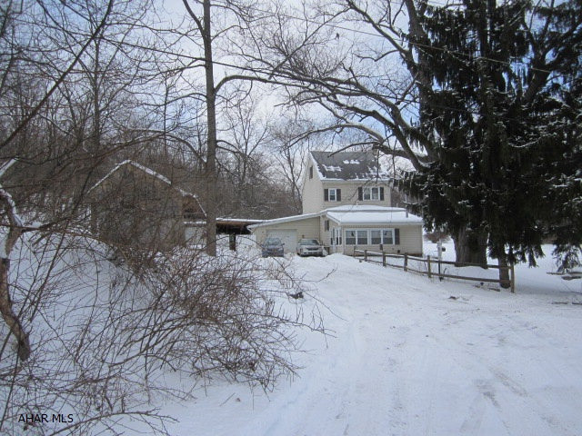 WANT PRIVACY IN THE MIDDLE OF TOWN? Located in Juniata a one of a kind property with 6+ acres. Sit at your kitchen table and look over the large grassy field nestled between wooded hillsides. The vinyl sided home has new windows and new furnace w/CA. There are multiple garages and heated work shop. Priced to Sell and super low taxes.