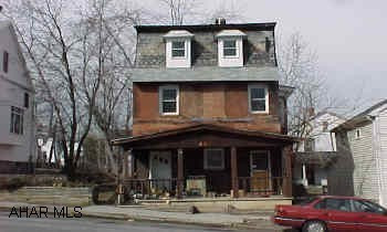 2.5 Story brick and frame possible duplex. Double lot, brick 2.5 story sold as is needs work was a duplex now single family garage with storage.