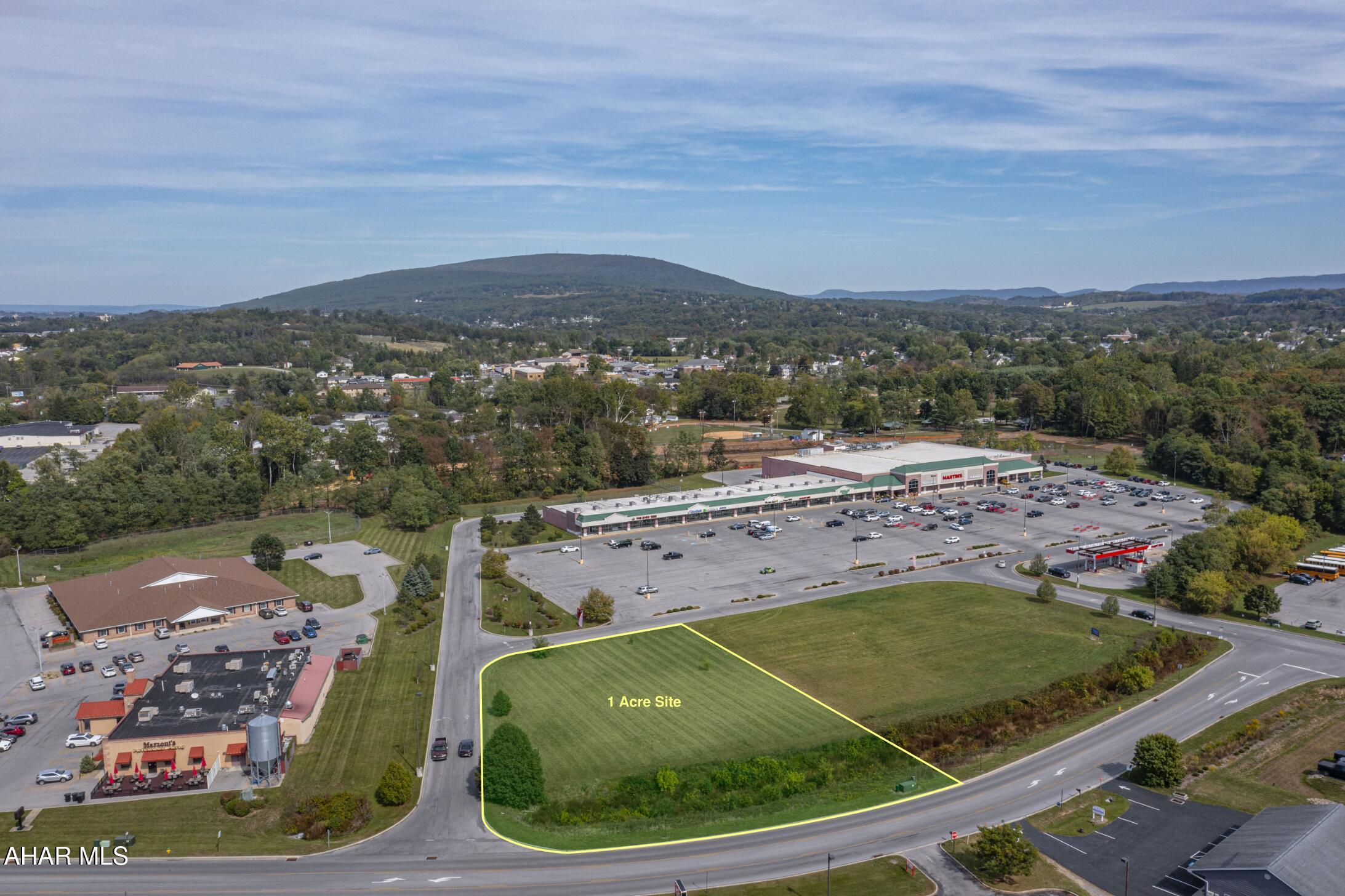 A prime 1-acre commercial parcel positioned at the entrance to Martins Grocery in the well-established Holliday Towne Center. This site offers excellent visibility, immediate access, and strong consumer traffic generated by surrounding national and regional tenants. Located just off Patch Way Road, the parcel benefits from direct access to Route 22 and close proximity to I-99 and Plank Road, connecting Duncansville, Altoona, and Hollidaysburg.
The lot is flat, cleared, and development-ready, with all public utilities available—ideal for a restaurant, bank, office, or retail user seeking a proven location in a high-traffic trade area.

Key Highlights:
±1.00-acre commercial parcel
Outparcel to Martins grocery store within Holliday Towne Center
Excellent access to Route 22, I-99, and Plank Road
Public water, sewer, gas, and electric available on site
Level topography for efficient site work and construction
Shared access drives and infrastructure within established retail center
Surrounded by strong co-tenancy

Why This Site Stands Out:
High visibility with frontage along a major retail access road
Established infrastructure reduces development lead time
Anchor-driven traffic from Martins Grocery and neighboring businesses
Proximity to I-99 and Route 22 supports regional access and logistics
Ready-to-build parcel within a cohesive, high-quality development