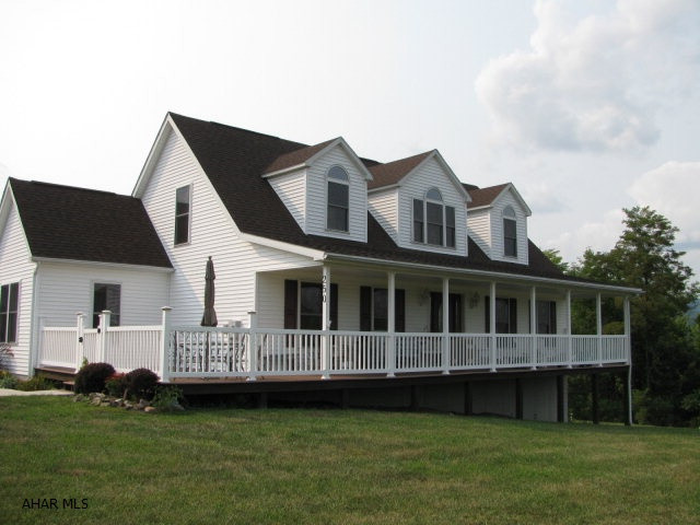 Charming Bellwood cape on 1.6 acres with spectacular views! This home offers spacious LR., DR., EIK., laundry 1/2 bath, master suite w/walk in closet and master bath all on 1st floor! 2nd floor includes 2 more large bedrooms, hall bath and loft area! 2 car oversized detached garage and full basement for storage. wrap around porch and large deck to enjoy the stunning views this home offers! Home Warranty included!