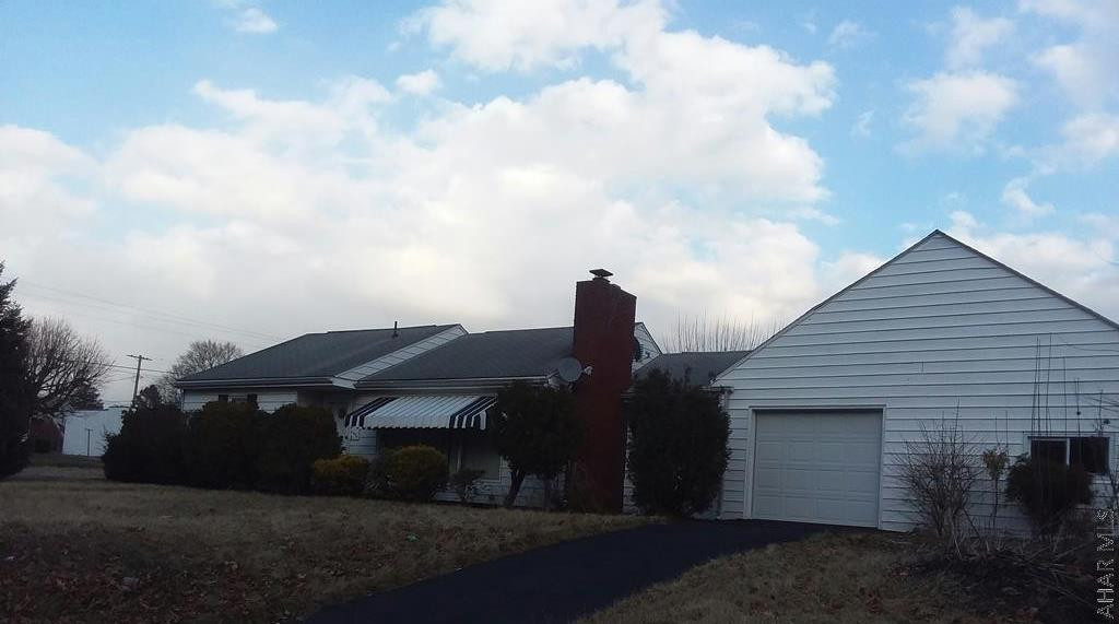 Corner lot on Pleasant Valley Blvd.. This  ranch home sits on 3 city lots features kitchen w/ appliances tile flr, dining room w/ hw flr, living room w/ fireplace hw flr, full bath, 2 bd, master bd w/ 1/2 bath, 2 car gar, shed, fenced in yard.
