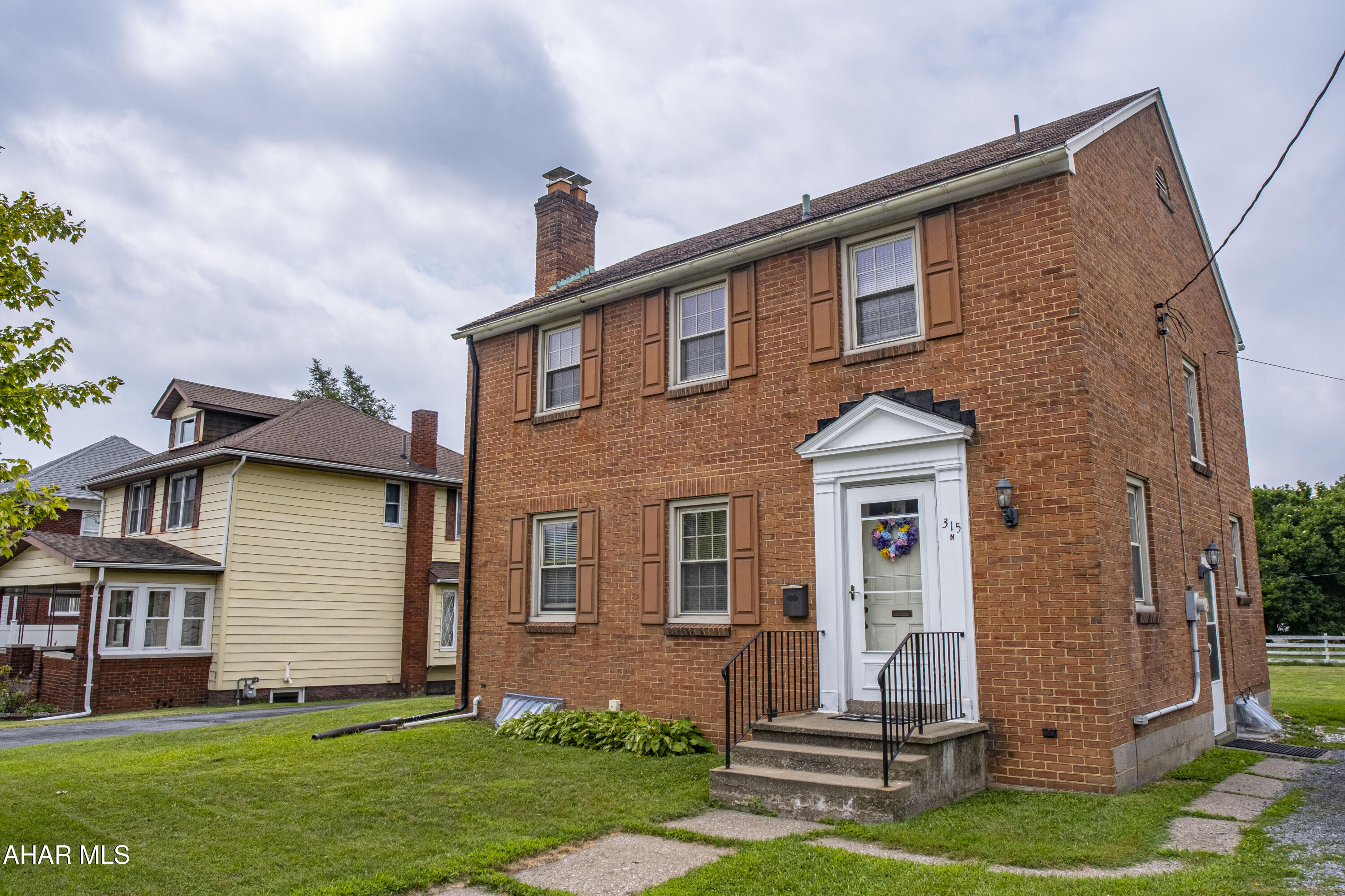 Charming two-story brick home ideally located directly across from Mansion Park in Altoona. This inviting residence offers a spacious open-concept living and dining area, highlighted by beautiful hardwood floors and a cozy fireplace—perfect for relaxing or entertaining. Upstairs, you'll find three comfortable bedrooms and a full bathroom. Additional features include off-street parking and a convenient storage shed. With quick access to major highways, including I-99, this home offers both comfort and convenience for commuters.