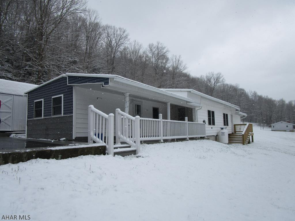 Updated single wide mobile home on over 3 acres.  Well maintained home featuring 3 bedrooms, 1.5 baths, large living room with vaulted ceiling, porch/deck, paved drive and one car garage.