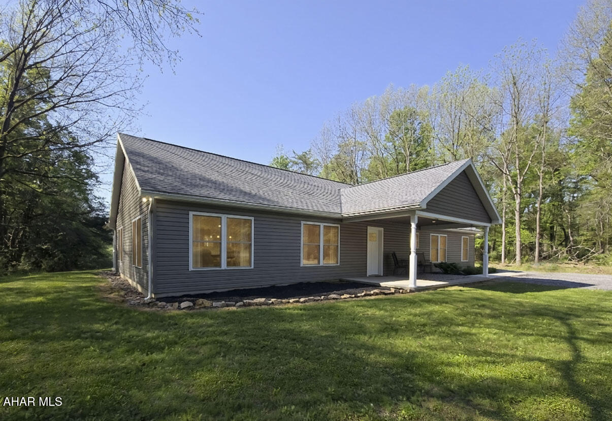 Welcome to 4236 Luke's Lane in Petersburg, a 2023-built home situated on an approximately 27-acre wooded site. Located in close proximity to State College/Penn State University (20 minutes) and Raystown Lake (Approx 30 minutes). This property offers a modern single-level layout in a private, natural setting with a mix of open yard space and surrounding woods. The home features 3 bedrooms and 2.5 bathrooms, with an open main living area that connects the living room, dining area, and kitchen.  Two of the three bedrooms have suite-style layouts with attached full baths.

Inside, the home showcases radiant-heated concrete floors, providing efficient and comfortable heat throughout, along with a separate HVAC system providing forced central air. The spacious kitchen includes wood cabinetry, ample counter space, pendant lighting, and a center island with seating. The main living area offers recessed lighting, ceiling fans, and large windows that bring in natural light and views of the surrounding property.

The home also includes a dedicated laundry area, well-appointed bathrooms, and comfortable bedroom spaces, including a primary bedroom with an attached bathroom. Outdoor living is enhanced by covered porch areas, a concrete patio/walkway, and a peaceful yard surrounded by trees. With newer construction, acreage, and a wooded setting, this property offers a unique opportunity for buyers seeking space, privacy, and modern comfort in the Petersburg area. Use coordinates for location 40.6413011, -77.9709852