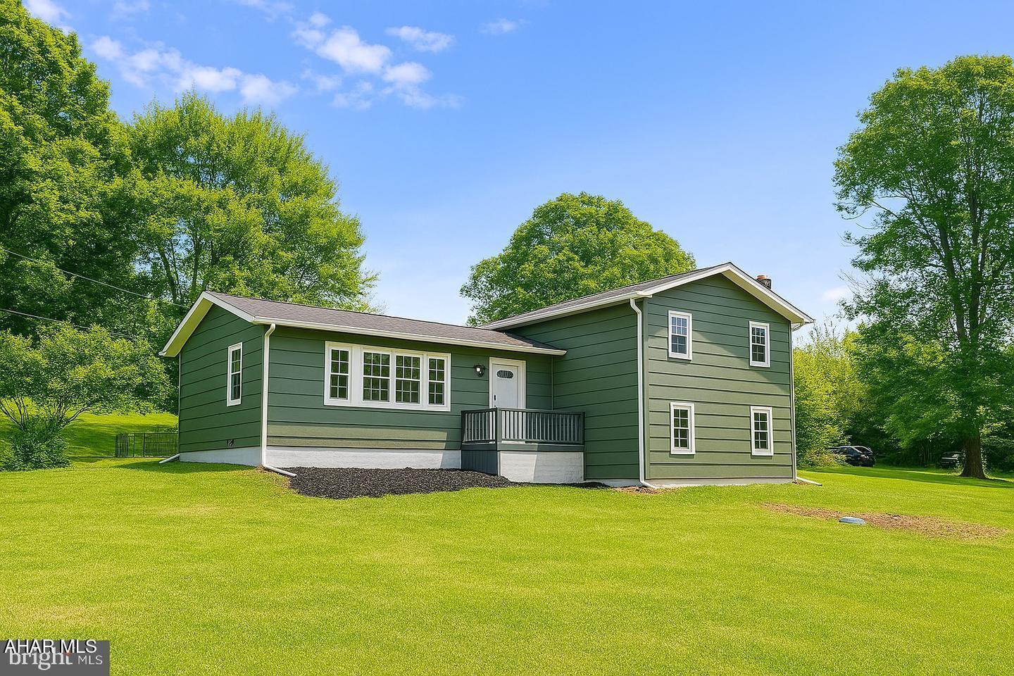 Don't miss this beautifully renovated 4-bedroom, 1.5-bath home nestled on a secluded 3.54-acre wooded lot that backs to thousands of acres of untouched land, giving you unmatched privacy, peaceful surroundings, and room to roam. Step inside to an open-concept living room and kitchen designed with both style and function in mind. The heart of the home features a large center island, sleek concrete countertops, stainless steel appliances, a spacious pantry, and a convenient water fill station above the stove, perfect for the home chef. The mix of hardwood and epoxy-poured floors adds a unique and eye-catching touch that sets this home apart. Upstairs, you'll find three comfortable bedrooms and a fully updated full bath with modern finishes. The lower level offers a fourth bedroom, a half bath, and a laundry/mudroom area with a rough-in ready for a dog wash station, ideal for pet lovers or outdoor enthusiasts. Outside, enjoy the natural beauty of your wooded surroundings and the quiet of country living. Two sheds are included, one equipped with electric, great for storage, a workshop, or hobby space. If you're looking for a home that combines thoughtful updates, functional space, and true privacy surrounded by nature, this is it. Welcome home!
