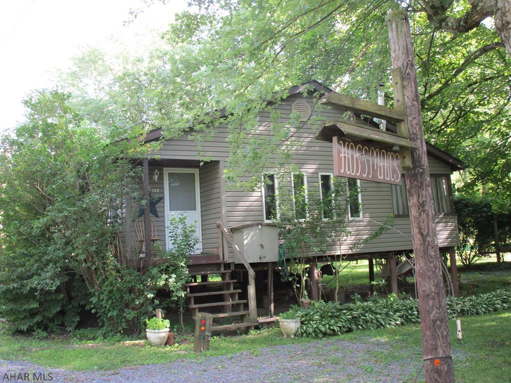 Perfect little getaway with spacious lot & Dunning Creek frontage in Camp Sunshine.  Association fees "previously" $35.00+-/ year approx.10 yrs. ago; since then, no fees have been assessed; however, that could change.  Subject to easements, conditions, restrictions, reservations....   Electric service type unknown (fuses or breakers). B.R.E.C. electric. Gross living area, age & site area are approximate; NO guarantees.  Public sewer & possibly public water are to be connected to this area; time line is unknown; contact Bedford Township 623-7879 or 623-8296.  Currently on a holding tank & well water. Some interior  finish needed. Cash or home equity loan only - SOLD AS-IS.