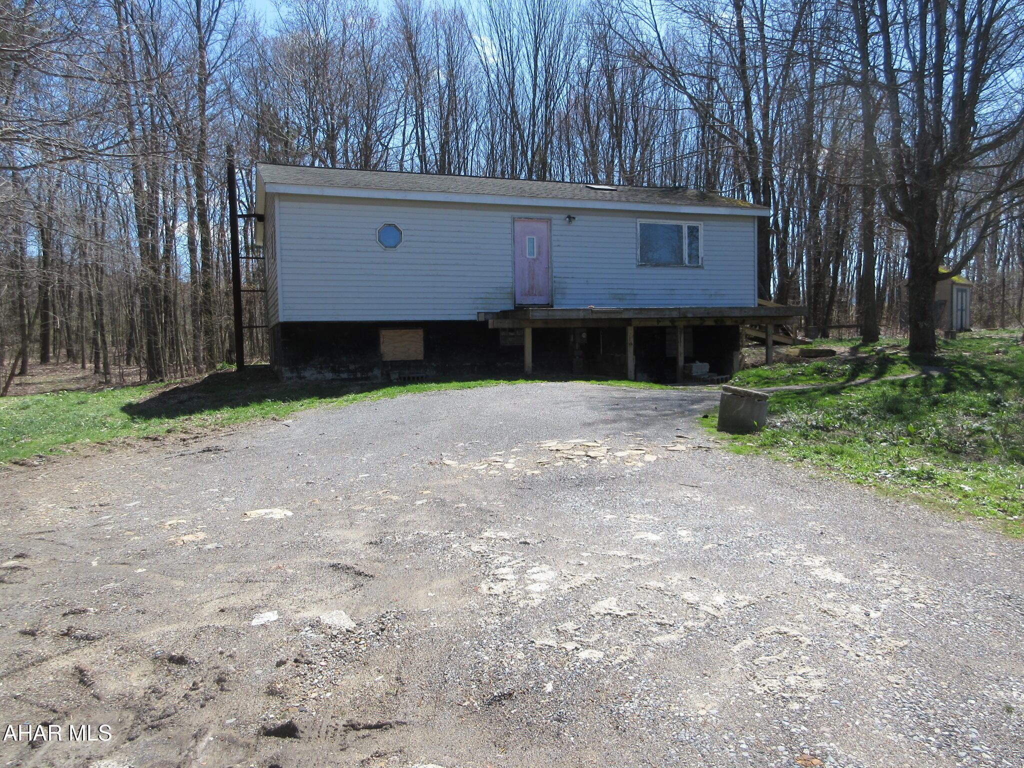 Hastings area double-wide home on 3.6 private acres. Perfect for investors or handy persons. Open concept main living area plus 2 bedrooms and walk-in shower. Needs TLC, but fantastic lot in a private setting. AS-IS sale, seller will make no repairs.  On-lot sewage system present; type and operational status are unknown. Furnace and plumbing system appear to be vandalized, non-functional.