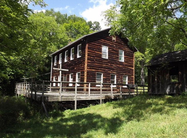 Private retreat on wooded acreage, tucked away in beautiful Juniata Township, Schellsburg! This rare find offers 2 wood burning fireplaces, hard wood floors and mountain views.