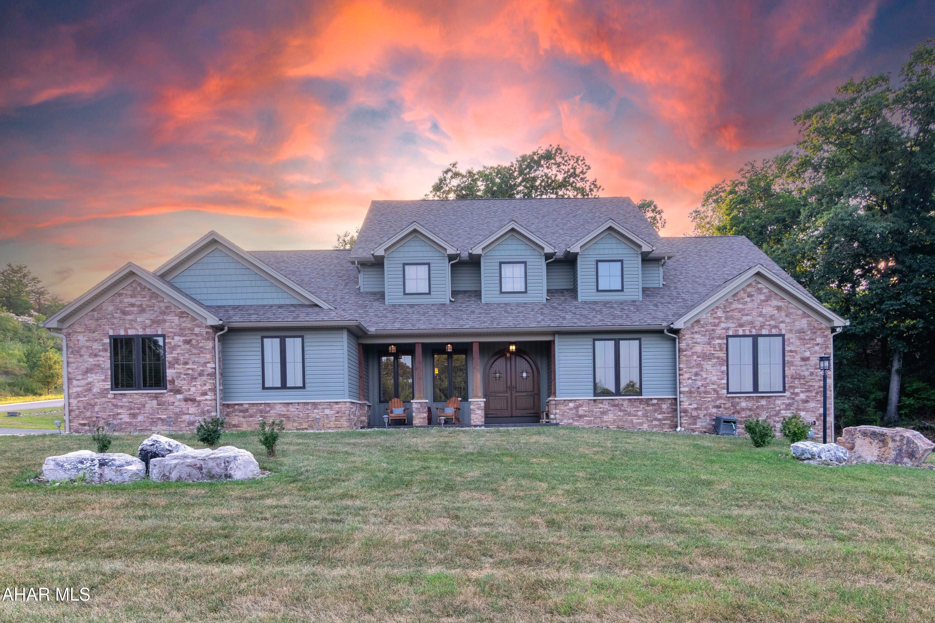 Exceptional home showcasing a seamless blend of high-end craftsmanship and modern convenience, situated in the sought-after Hollidaysburg Area School District. This expansive 5-bedroom, 6-bath residence offers a thoughtfully designed layout with upscale finishes throughout.

The living room features soaring ceilings, a floor-to-ceiling stone fireplace, and large windows that flood the space with natural light.

The gourmet kitchen is equipped with custom cabinetry, professional-grade appliances, and a built-in surround sound system—also extended into the primary bedroom and finished basement. The main level includes a formal dining room, a spacious laundry/mudroom, a dedicated home office, and a luxurious first-floor primary suite with a spa-inspired bath complete with a freestanding soaking tub and tiled walk-in shower. Hardwood floors, solid wood trim, and meticulous detailing are found throughout.

Upstairs offers four additional generously sized bedrooms. The finished lower level provides a home gym, full bath, sauna, and versatile flex space perfect for a media room, guest suite, or secondary office—also wired with built-in surround sound.

Additional features include a built-in alarm system for peace of mind and an attached three-car garage. Outdoor amenities include a stamped concrete front porch, a rear concrete patio with wooded views, and an arched double-door entry. All located in a peaceful setting just minutes from schools, shopping, and conveniences.
(PREAPPROVED BUYERS ONLY.  Buyer to confirm sq footage, lot size, taxes, deed restrictions.)