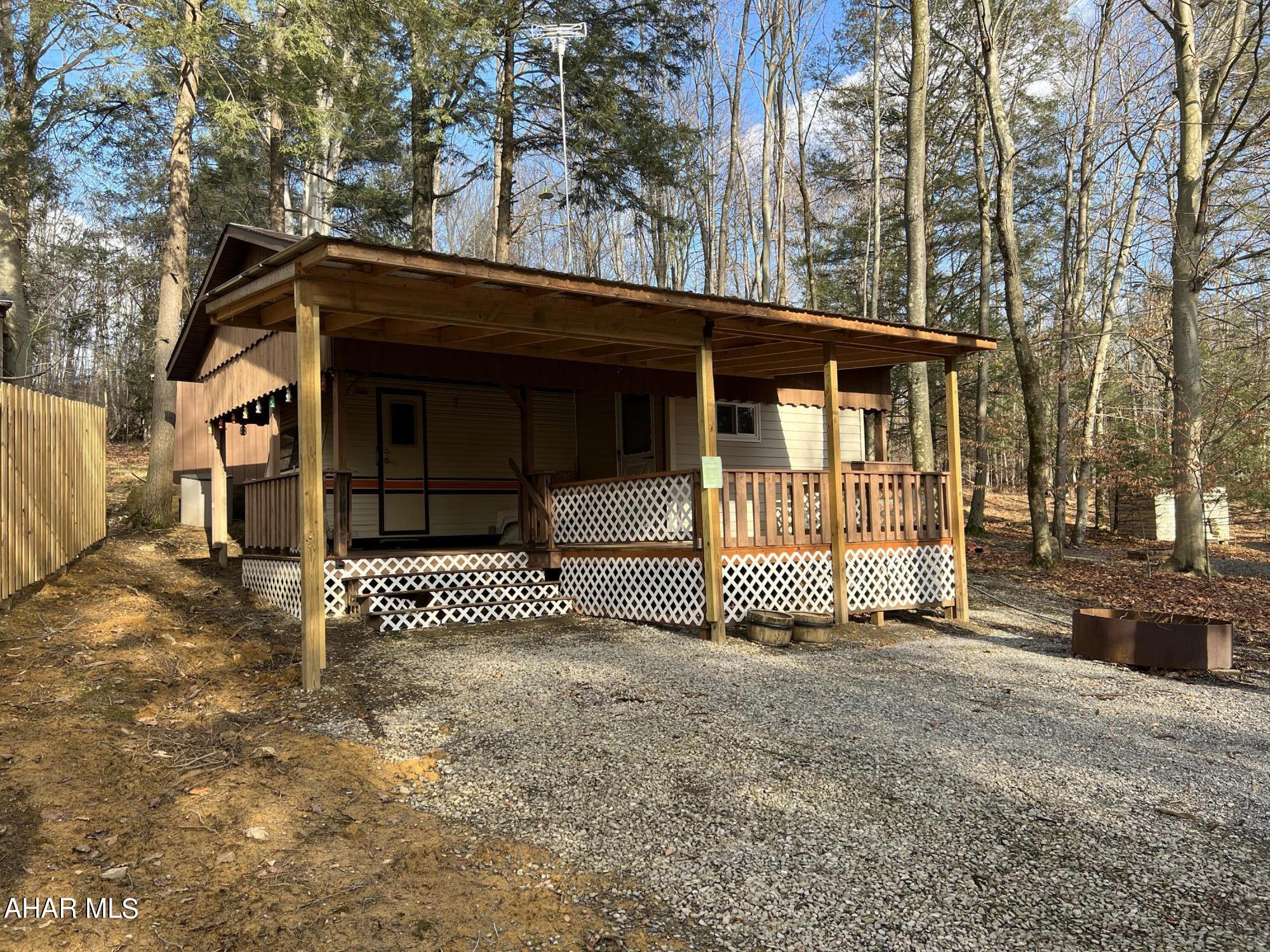 Get a jump on the 2023 camping season with this camper/cabin in Glendale Yearound. An addition to the camper expands the kitchen/living area for more space. Bathroom has a full size walk-in shower. Roof enclosure over the camper with an extra large deck. There's also a nice sized shed in the back, rear yard faces woods. Spring will be here before you know it!