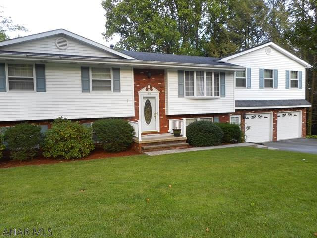 This very special multi-level 4 bedrm, 3 bath home is  on a gorgeous lot. Main level has an updated kitchen with lovely cabinetry, new counter top and ss appliances. Dining rm, with a slider to a deck, has a tremendous view. Living rm, dining rm and kitchen have new pergo flooring. 3 bedrms and full bath complete this level. Upper level has a convenient laundry rm and spacious m. bedrm w/large walk-in closet and m. bath. What a surprise the lower level will be. Large family rm with corner kitchen and full bath. Great for mother-in-law suite or adult children  living at home. Off the family rm is a bright and cheery all season rm. Another bonus rm plus a finished rm behind garage can be used as a workshop. Best of all GREAT LOCATION!! Conveniently located to Mall, schools and stores.