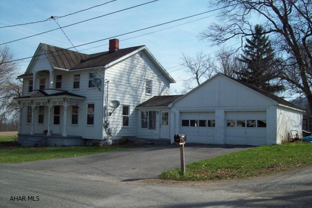 Enjoy small town living in this 2-story Victorian home with 4-bedrooms, 1.5 baths and first floor laundry.  Other features include an enclosed breezeway, attached 2-car garage, level lot and a small decorative pond.