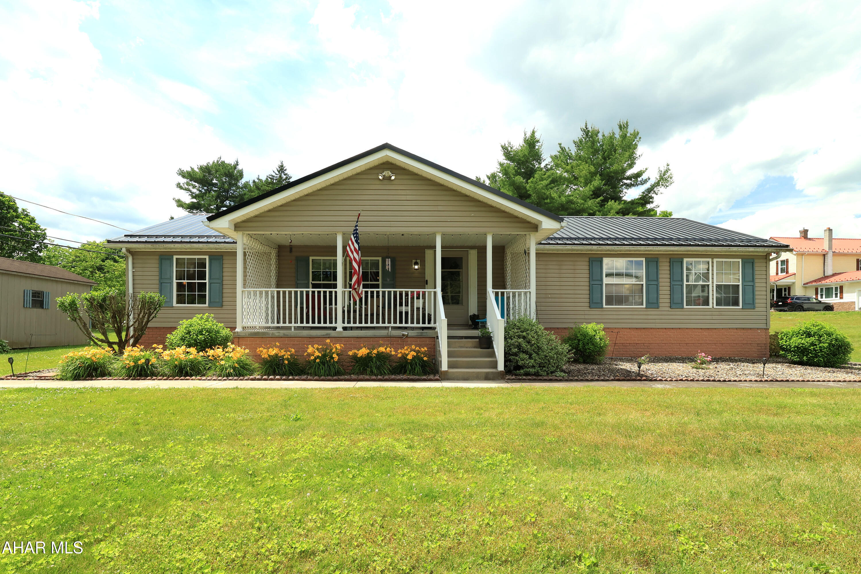 Welcome home to this well-maintained 3-bedroom, 2-bath residence on a corner lot, thoughtfully updated with a brand-new metal roof and designed for comfortable everyday living. From the moment you step onto the inviting front porch, you'll appreciate the care and pride of ownership found throughout this property. Inside, you'll find a welcoming living space with a functional layout that flows naturally from room to room. The spacious primary bedroom offers the convenience of its own en-suite full bath, creating a private retreat at the end of the day. Two additional bedrooms and a second full bath provide flexibility for you to make each space your own. As you move through the home, natural light and comfortable living areas create a welcoming atmosphere. The rear sunroom extends your living space and offers the perfect spot to enjoy morning coffee, unwind with a book, or gather with friends while overlooking the backyard. Outside, the large lot provides plenty of room for outdoor activities or gardening.Whether relaxing on the front porch or enjoying the peaceful setting from the back sunroom, there are multiple spaces to appreciate the outdoors. Conveniently located near Bellwood-Antis Community Park, you'll have easy access to a playground, swimming pool, basketball courts, volleyball courts, and additional recreational amenities. Combining a desirable location, a spacious lot, a practical floor plan, and the lasting value of a new metal roof, this property offers an exceptional opportunity to enjoy comfortable living both inside and out.