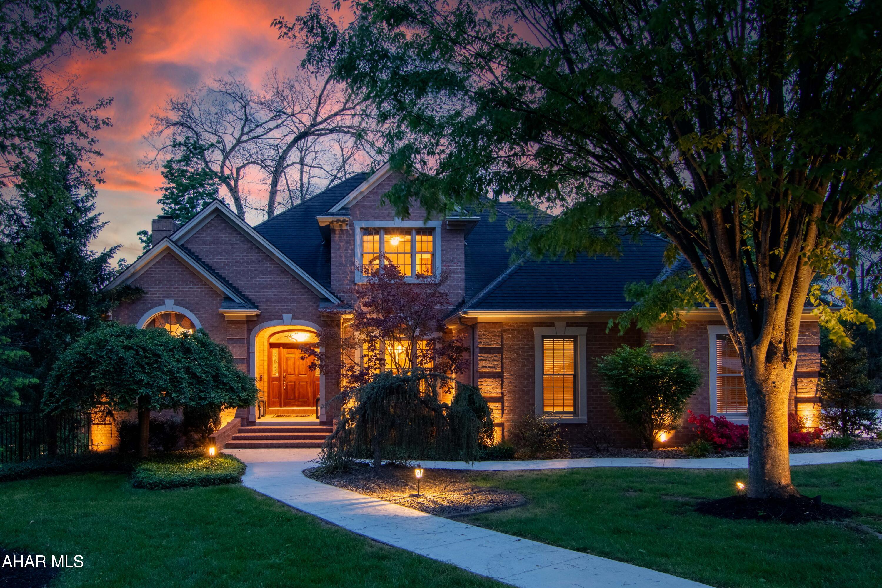 Stunning custom brick traditional home offering timeless architecture, exceptional living space, and impressive indoor-outdoor entertaining areas. Situated on a beautifully landscaped lot, this residence features dramatic curb appeal with  exterior lighting, mature trees, and a welcoming covered entry. Inside, spacious living areas showcase oversized windows, abundant natural light, recessed lighting, and a cozy fireplace creating a warm and inviting atmosphere.
The expansive kitchen offers abundant cabinetry, new countertops, center island seating, and generous prep space ideal for everyday living and entertaining. The 1st floor primary suite provides a relaxing retreat with large windows, custom trim details, and ample space to unwind. Multiple living and gathering spaces throughout the home provide flexibility for entertaining, recreation, or work-from-home needs.
Outdoor amenities include a screened-in porch, covered deck and patio areas, as well as a beautifully maintained yard surrounded by mature landscaping and wooded views. Additional highlights include an attached multi-car garage, quality brick construction, and thoughtfully designed outdoor living spaces that extend the home's functionality year-round.
This exceptional property combines classic traditional styling with spacious modern living in a picturesque setting. Call today to schedule a private tour. (Offer deadline 5/9/2026-3pm)