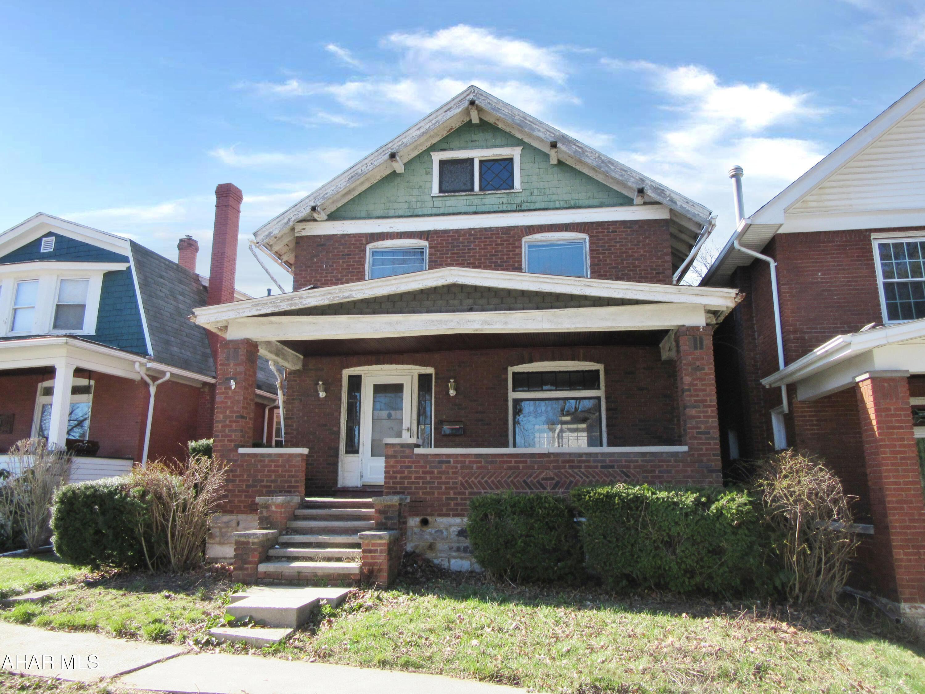 Spacious brick two story with lots of potential, nice covered deck and large parking area, freeze damage in the hot water heating system