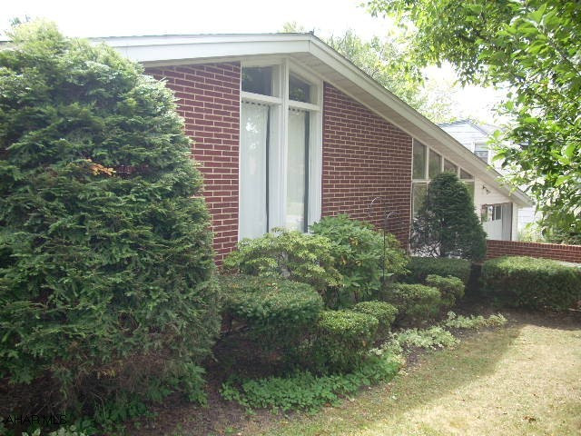 Very nice ranch home on large lot with fenced area off rear patio. Hardwood floors, cathedral ceilings, updated electrical,updated appliances, entire house freshly painted. 1 car attached garage plus 3 car detached garage. Great sunroom with ceramic tile floor. Move in condition! Car Buffs Dream to have large detached garage or terrific workshop!! Nicely finished basment w/ full bath and bedroom or office, laundry room and walks out to the fenced back yard.